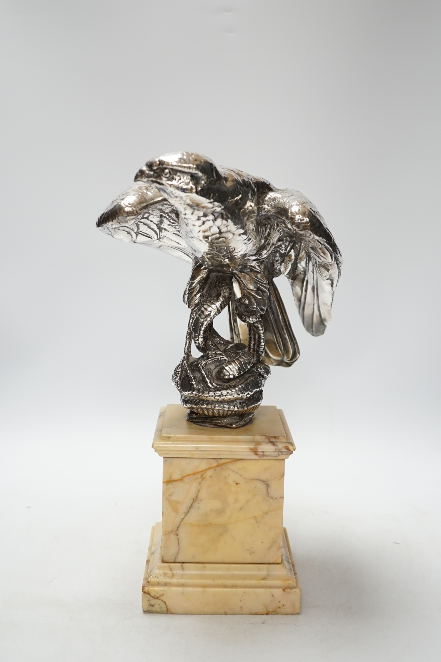 A silvered bronze falcon and serpent group, on marble pedestal, 37cm